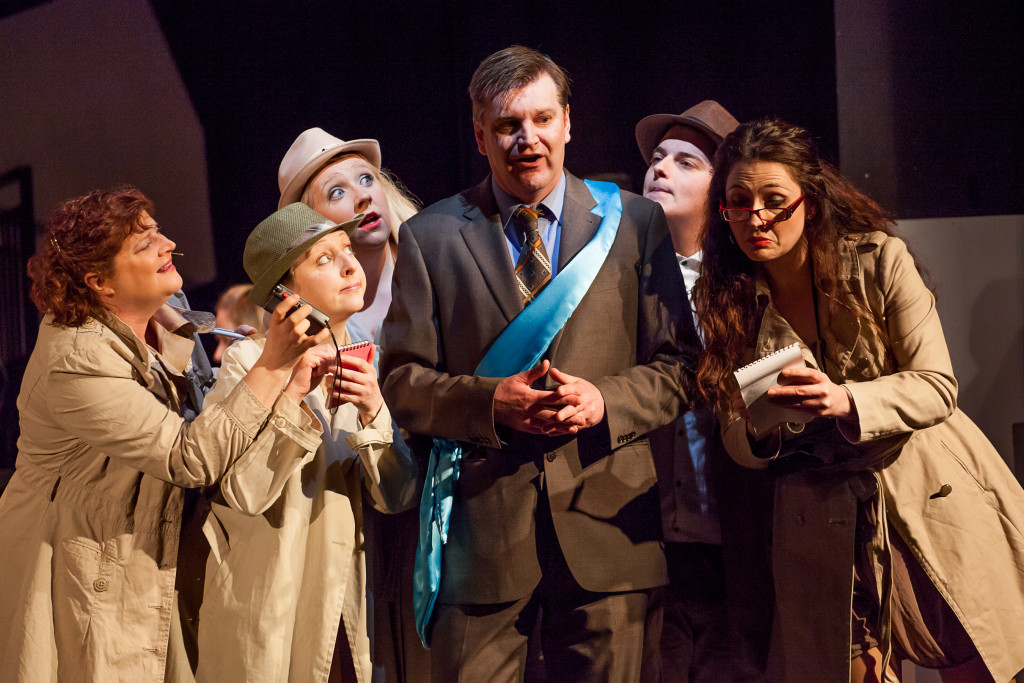 Reporters surround the Mayor of Merano, the scene of the first international chess championship in Chess: The Musical. L-R Hazel Beattie, Caroline Hood, Lauren Jack, Hamish McCool, David Doherty, Henrietta Linnemann.