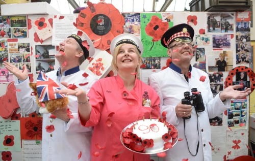 Robert Watson, Pauline de la Cruz and Arthur Dyke with the cake at the Poppy Factory 