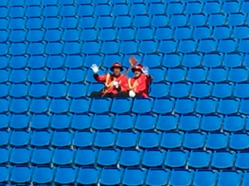 Two members of the New Zealand Army Band have a seat in the stand after the exertions of their Haka!