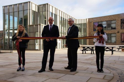 Cabinet Secretary for Education John Swinney is joined by Education Convener Cllr Paul Godzik and the two youngest pupils at James Gillespie's High School, Anna Green and Jeong Ing Park (both 11 years) for the cutting of the ribbon at the official opening.