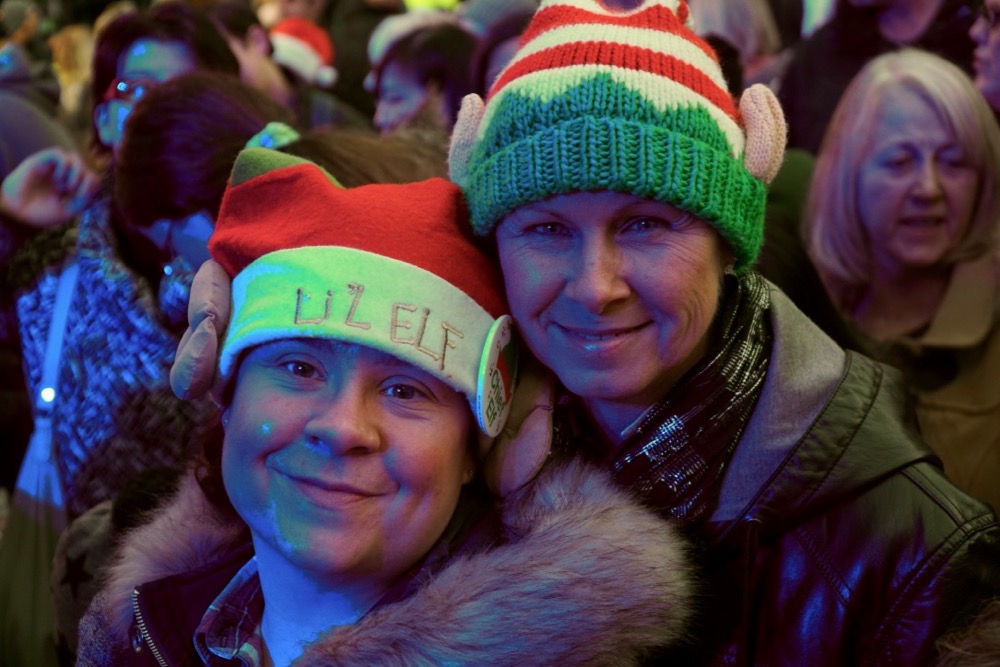 Two ladies wearing elf hats