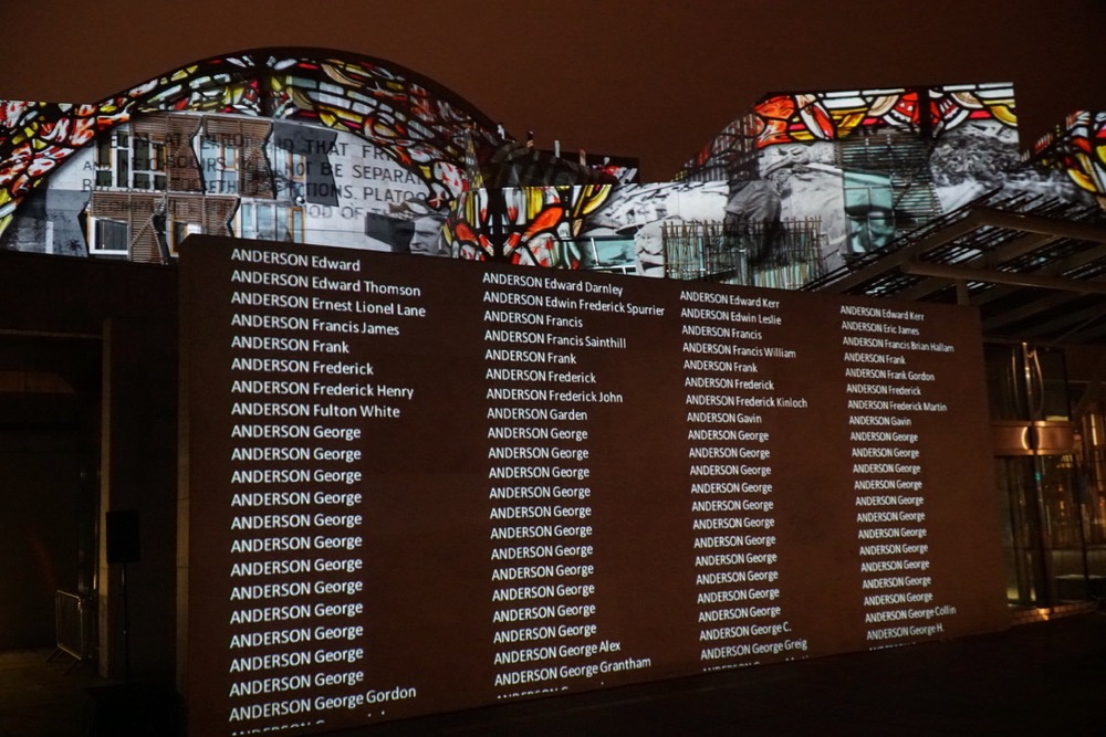 Scottish Parliament with projections illuminating the facade