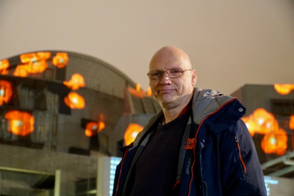 Headshot of Ross Ashton with Holyrood behind