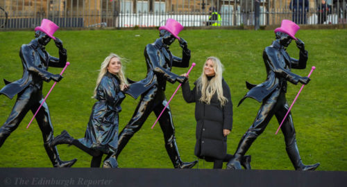 Blond twins with striding statues