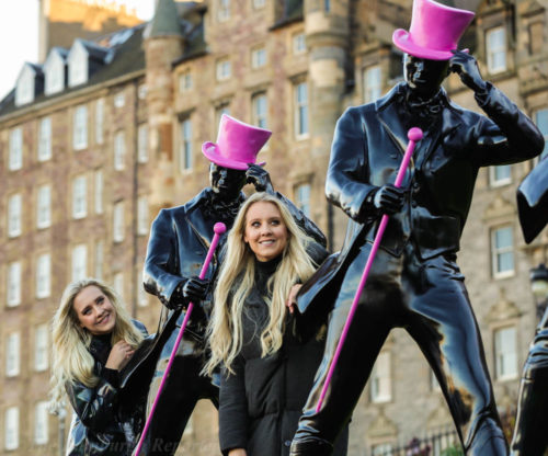 Blond twins with striding statues