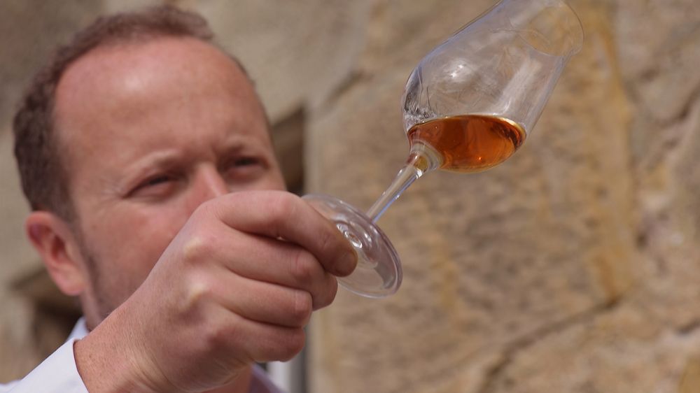 Alex Bruce with glass of whisky