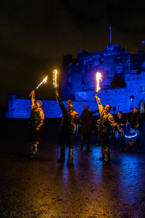 Three men with fiery swords in front of blue castle