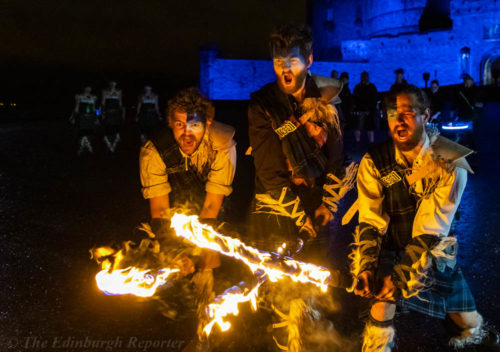 Three men with fiery swords in front of blue castle