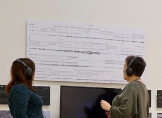 Audio visual exhibition with two people listening with headphones