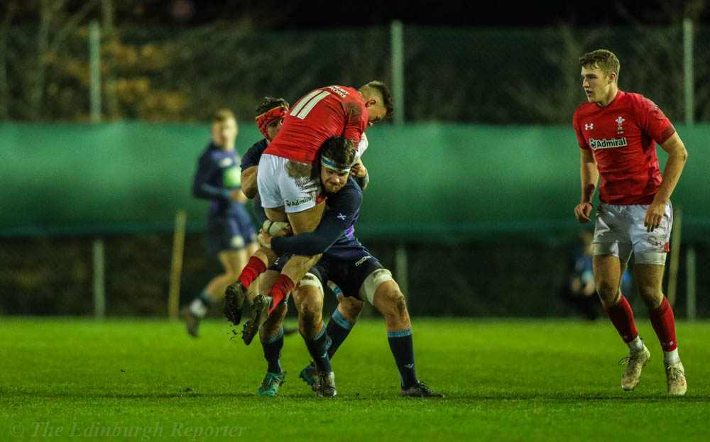 Two Scottish players tackle Welsh player