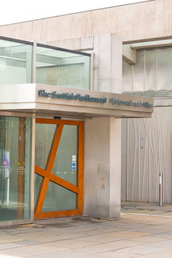 public entrance at Scottish Parliament building with words The Scottish Parliament above door