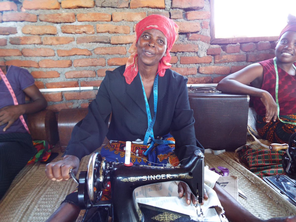 African woman using Singer sewing machine sent by Garvald