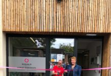 Two people outside Garvald premises cutting the ribbon