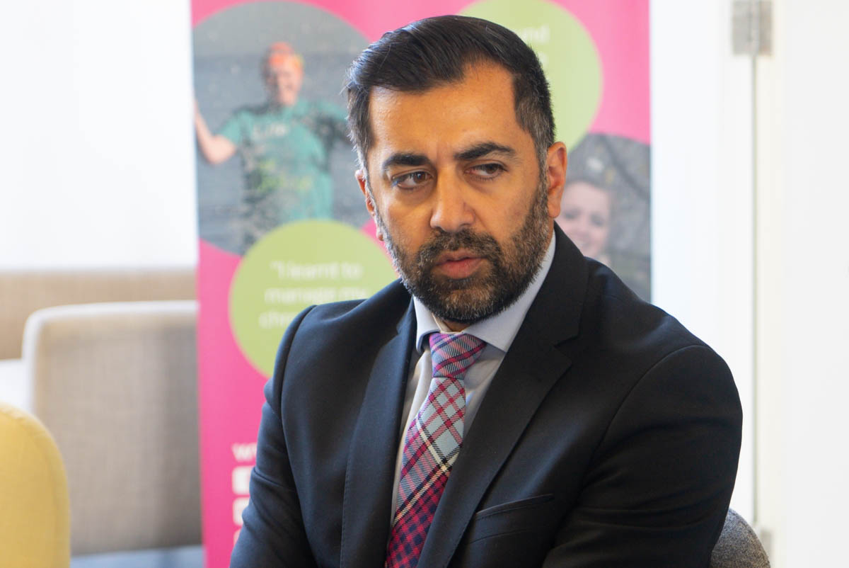 Man dressed in business attire in close up looking off screen to right