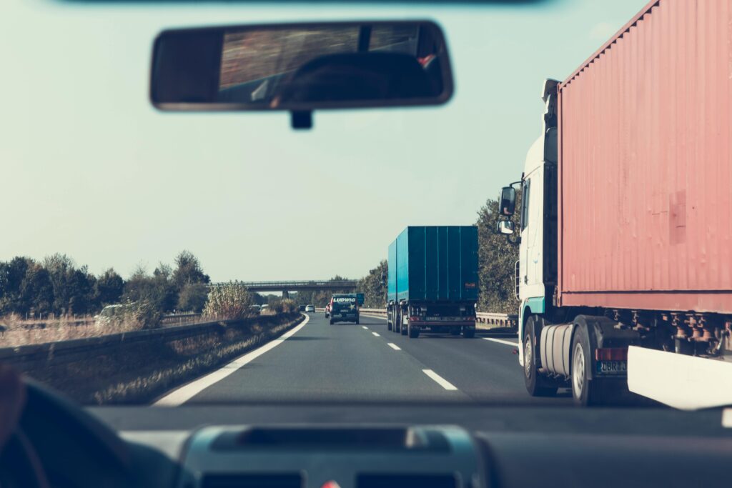 Photo by Markus Spiske: https://www.pexels.com/photo/blue-and-red-freight-truck-on-road-172074/