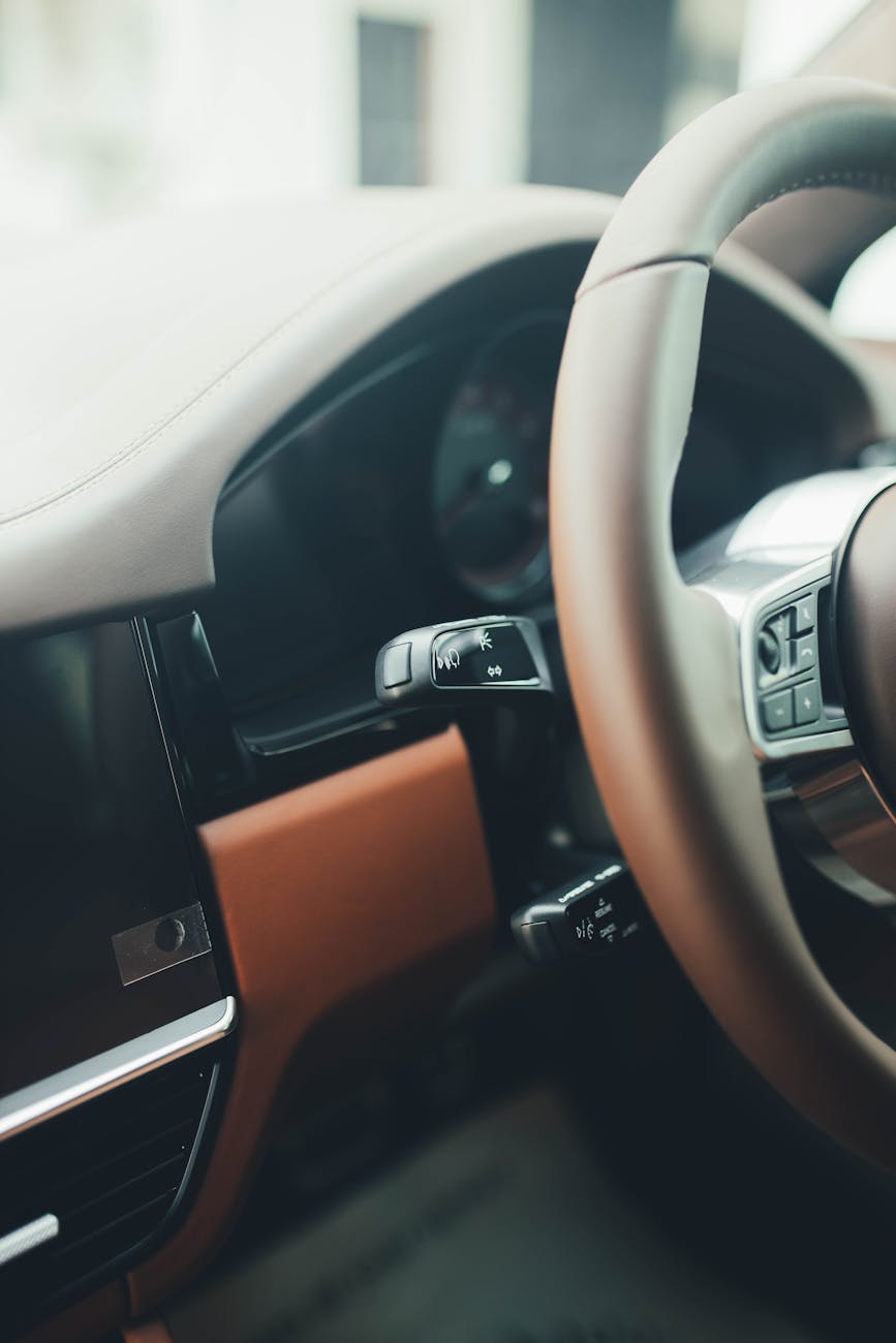 close up of a luxury car dashboard and steering wheel